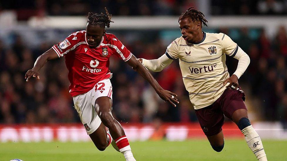 Issa Kabore (left) is challenged by Burnley's Largie Ramazani