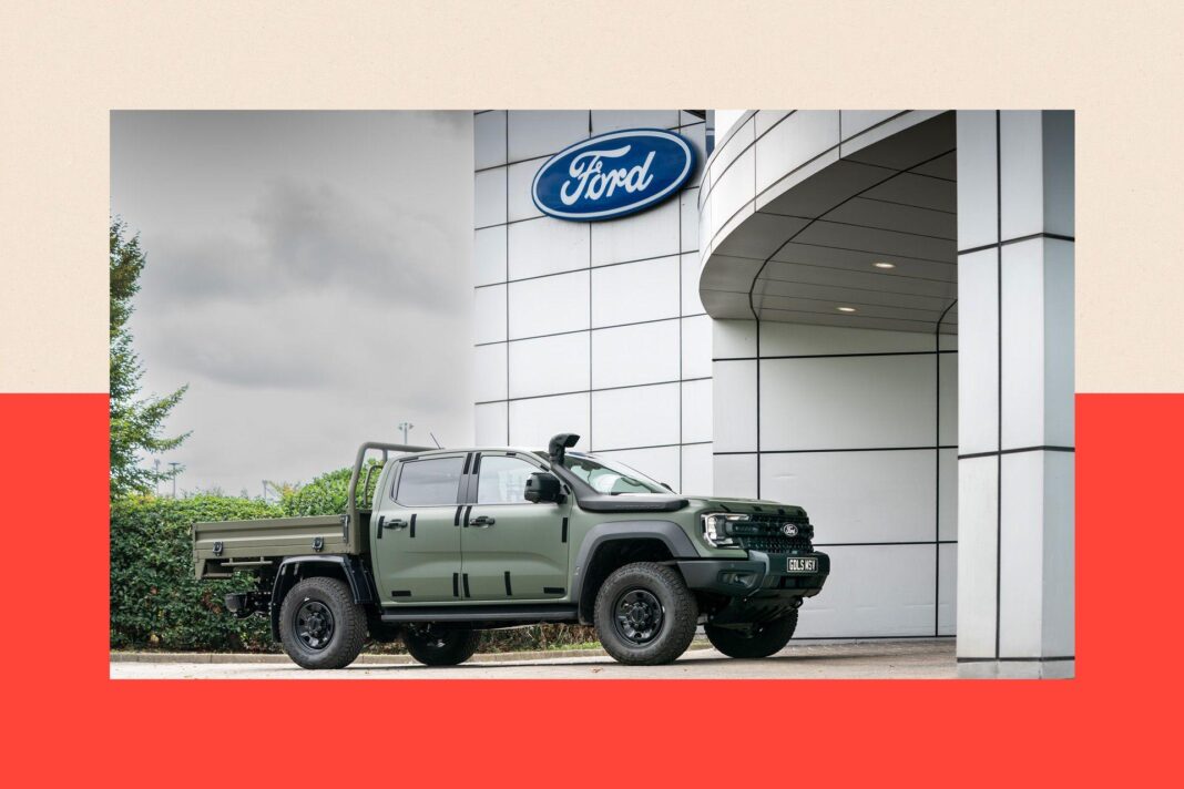 Europe’s car makers are in crisis. Will the threat of war rescue them? A variant of Ford's Ranger, built for military duty, sits outside the entrance to Ford's Dangenham plant underneath the company's logo.