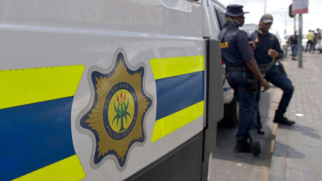 File photo of South African Police Service (SAPS) officers standing near a police van in Johannesburg
