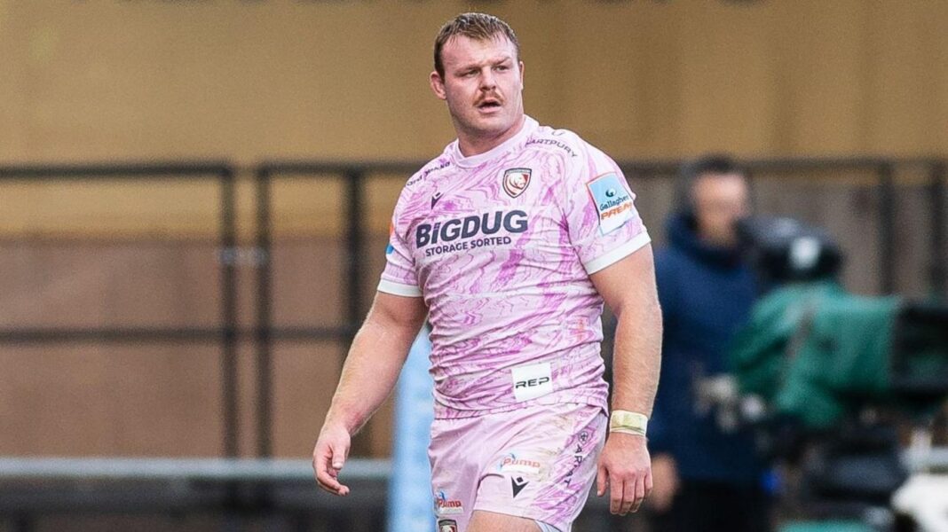 Dewi Lake, wearing purple Gloucester away kit, standing on the pitch with his arms by his sides