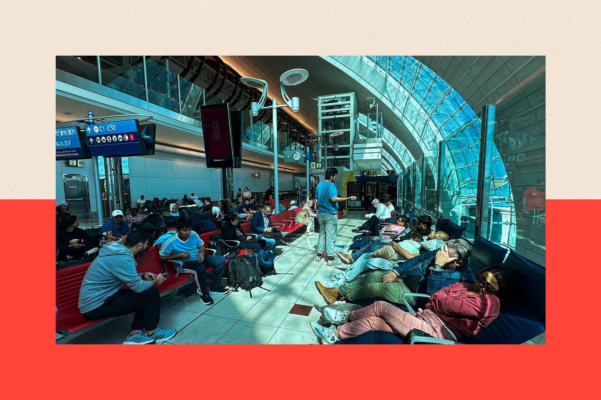 An airport terminal full of people waiting