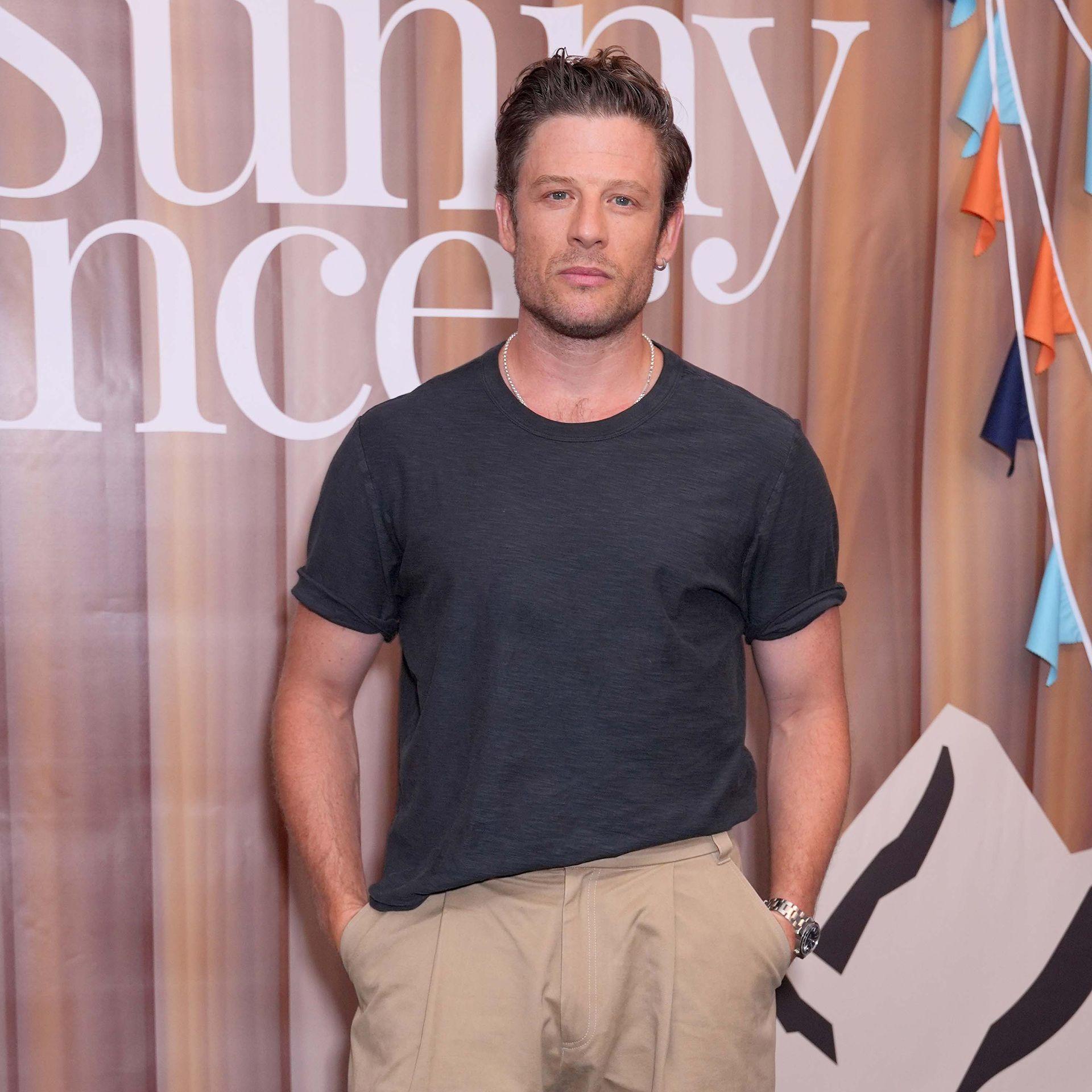 James Norton looks at camera while standing with hands in pockets at a premiere in London in August.