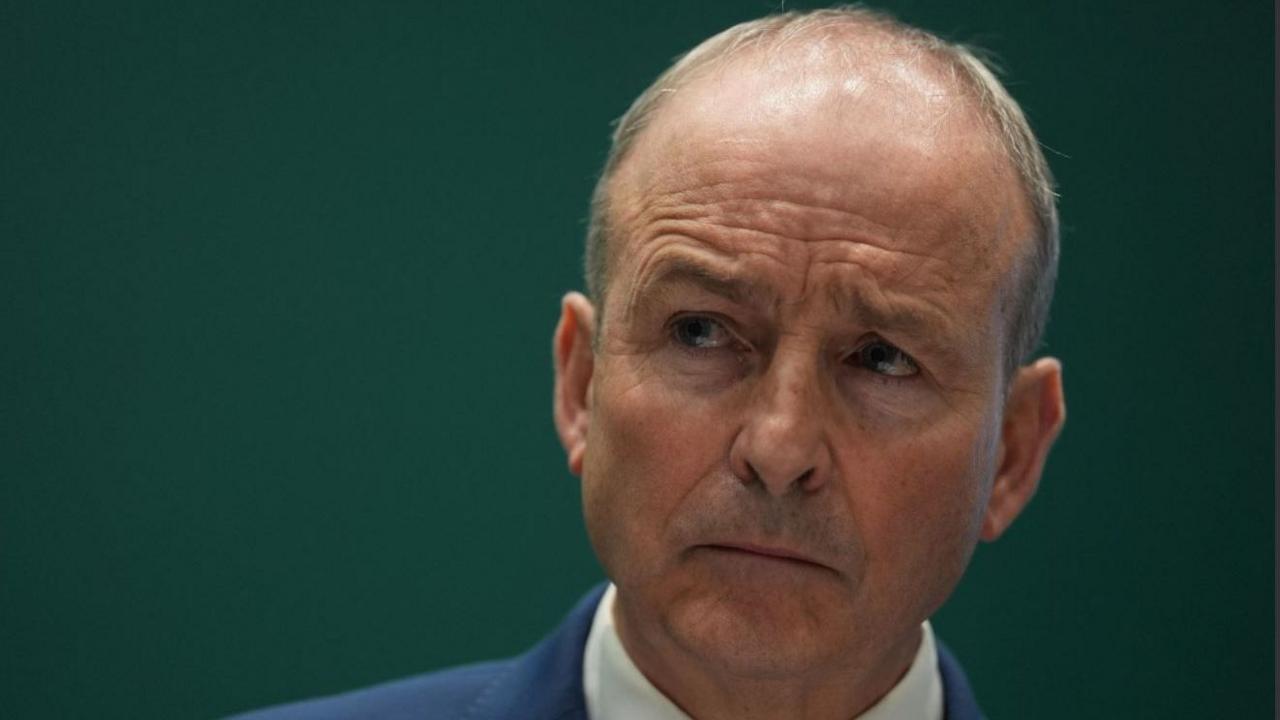 Micheál Martin, a man with grey hair, wearing a blue jacket and white shirt.