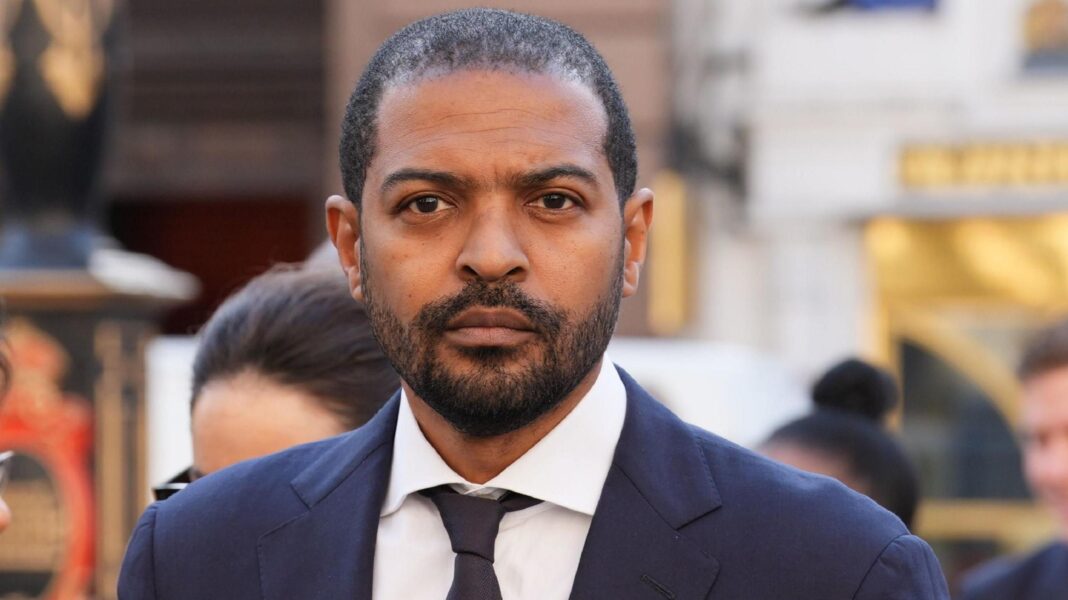 Actor Noel Clarke charged with sexual offences Noel Clarke in a dark suit outside court