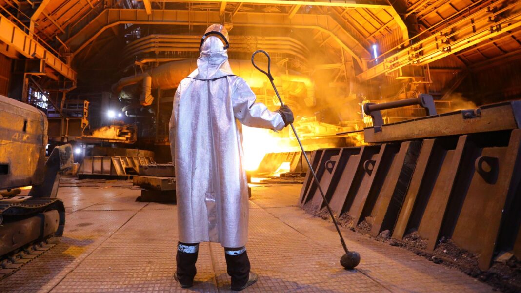 Ukraine’s prized steel industry left in ruins by Russian missile campaign A man in a silver cloak stands near a blazing furnace holding a metal prod