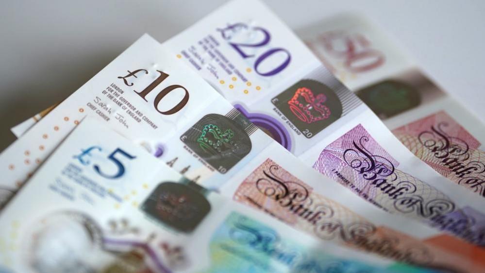 Burnham to tackle ‘mega-donors’ in UK politics, minister says Four banknotes are in a pile on a table. Each banknote is partially obscured. There is a £50 note in the background which has a £20 on top of it. A £10 is on top of the £20, and a £5 is on top of the £10.