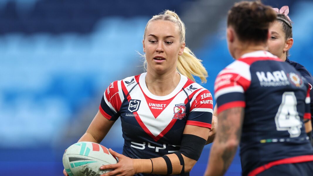 Jasmin Strange runs with a rugby ball