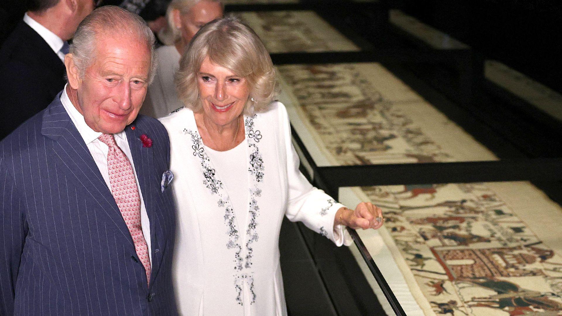 King Charles and Queen Camilla looking at the Bayeux Tapestry