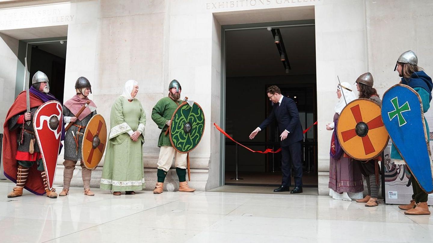 Re-enactors dressed in costumes from the Battle of Hastings era outside the exhibition
