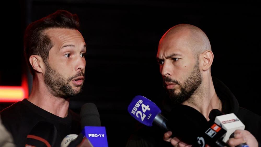 Tristan (left) and Andrew Tate speaking to members of the media in March 2025.