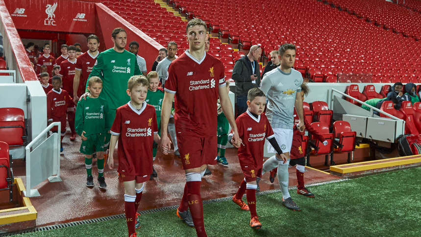 Joe Riley (right) leads Manchester United out against Liverpool at Anfield in an under-23s fixture in 2018