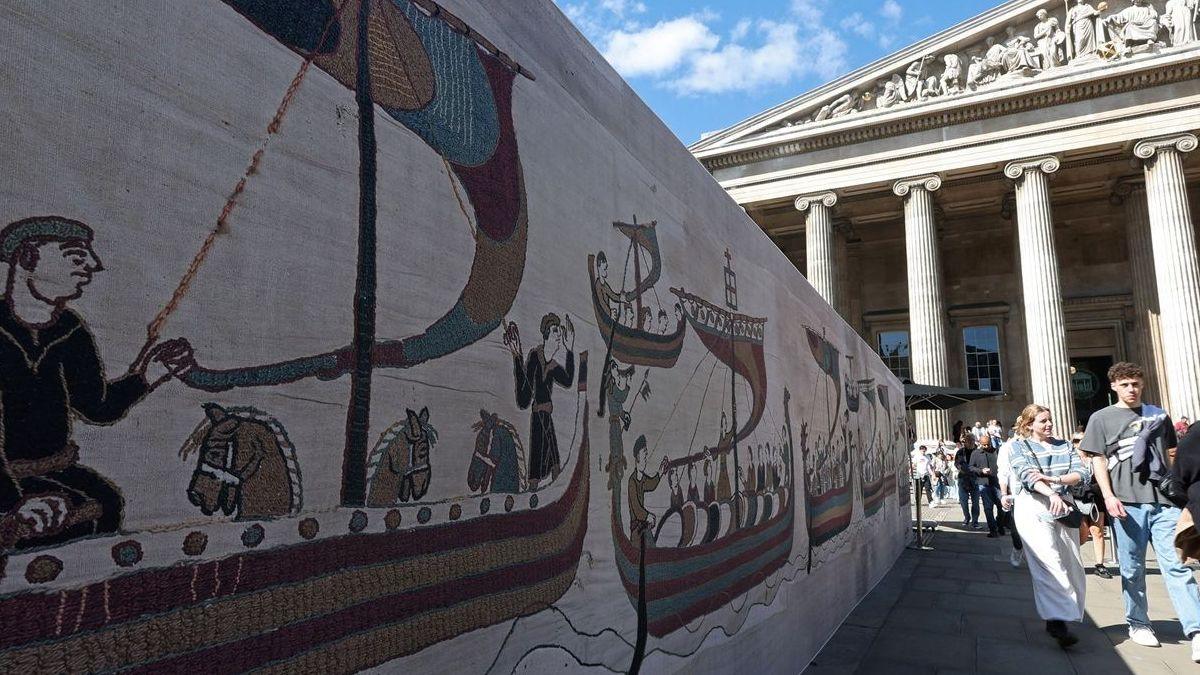 People walk past an advertisement promoting the Bayeux Tapestry, going on view at the British Museum in London, Britain, September 10, 2026