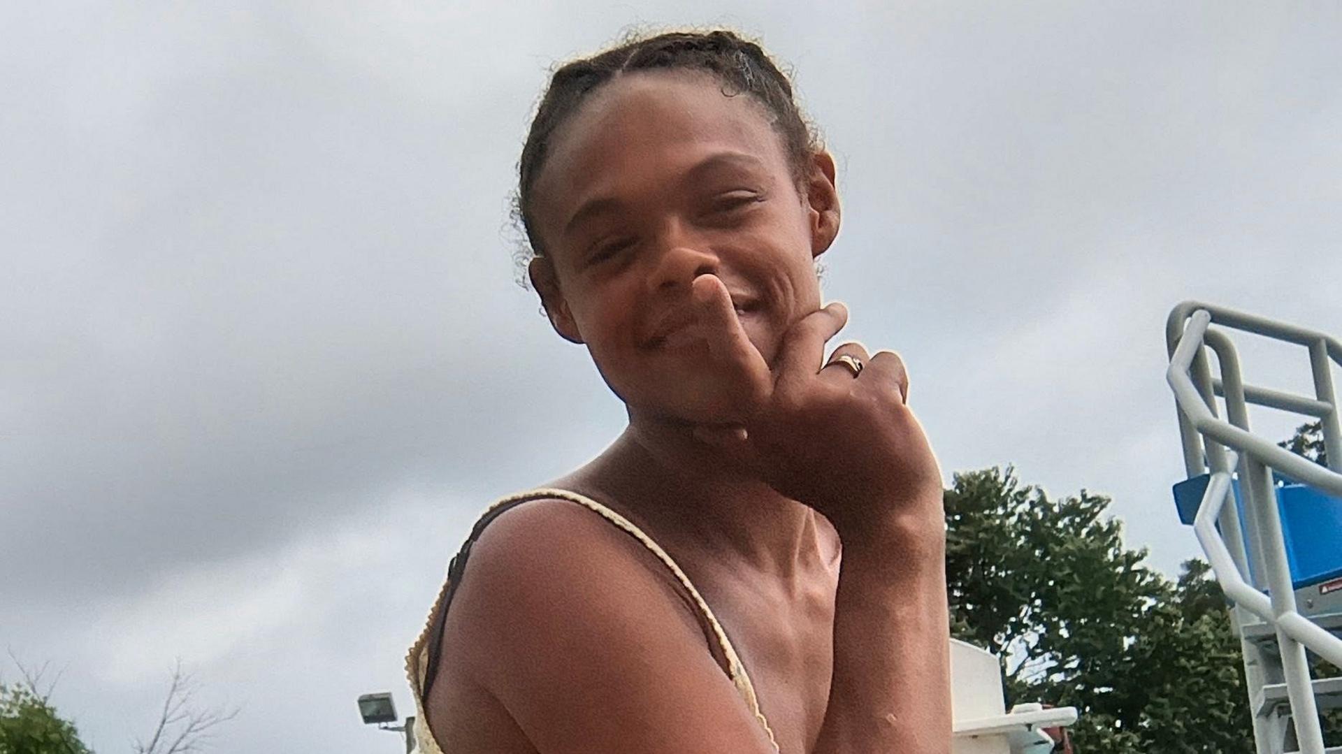 Tasia Fortune holds a finger to her lips and smiles in a family handout photo
