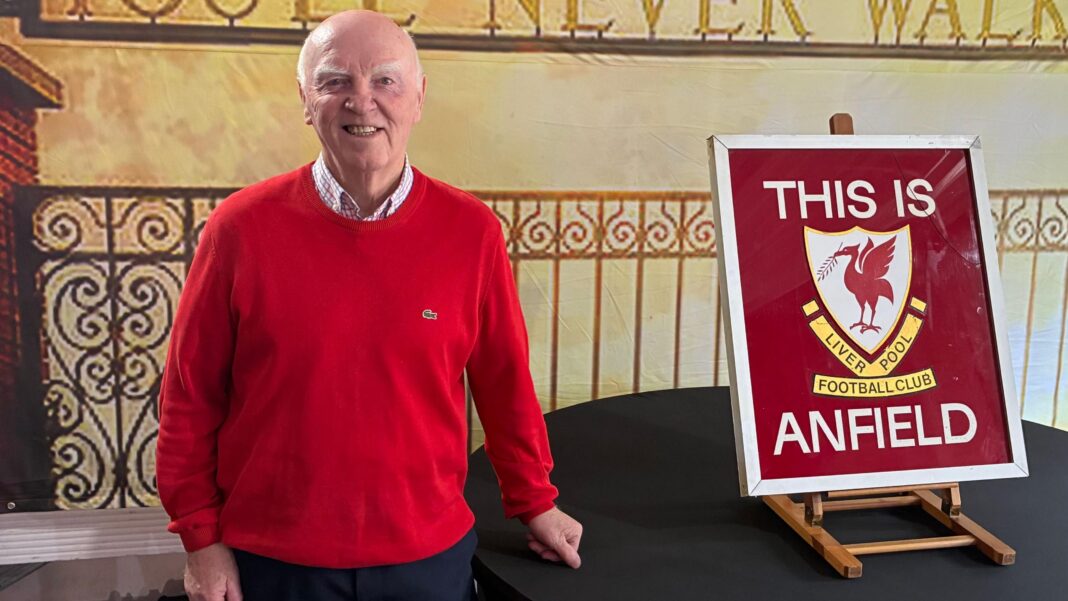 ‘This Is Anfield’ sign fetches £115k at auction A man in a red jumper stands next to the 'THIS IS ANFIELD' sign which sits on a balck table.