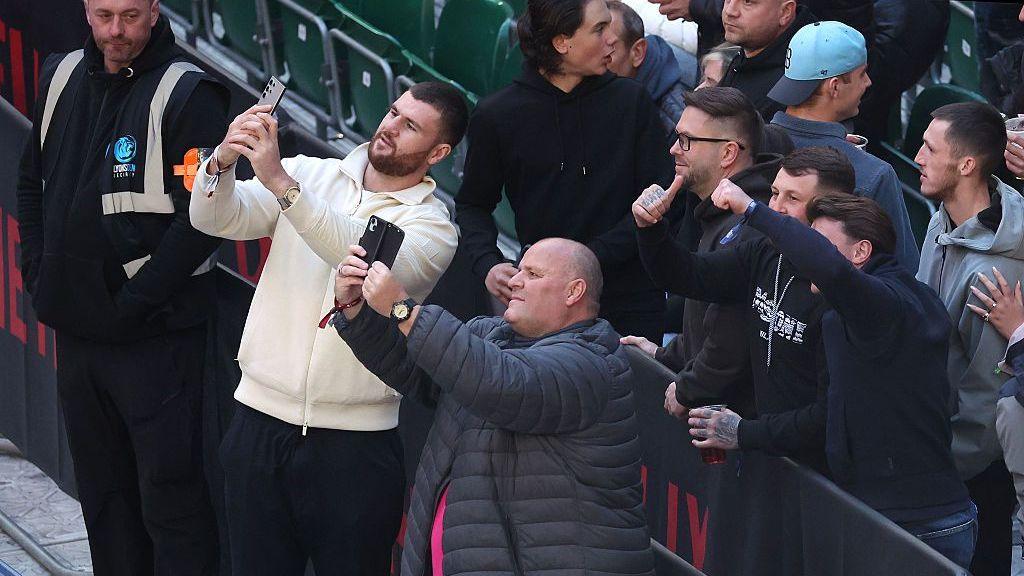 Johnny Fisher and 'Big John' pose for photos with fans