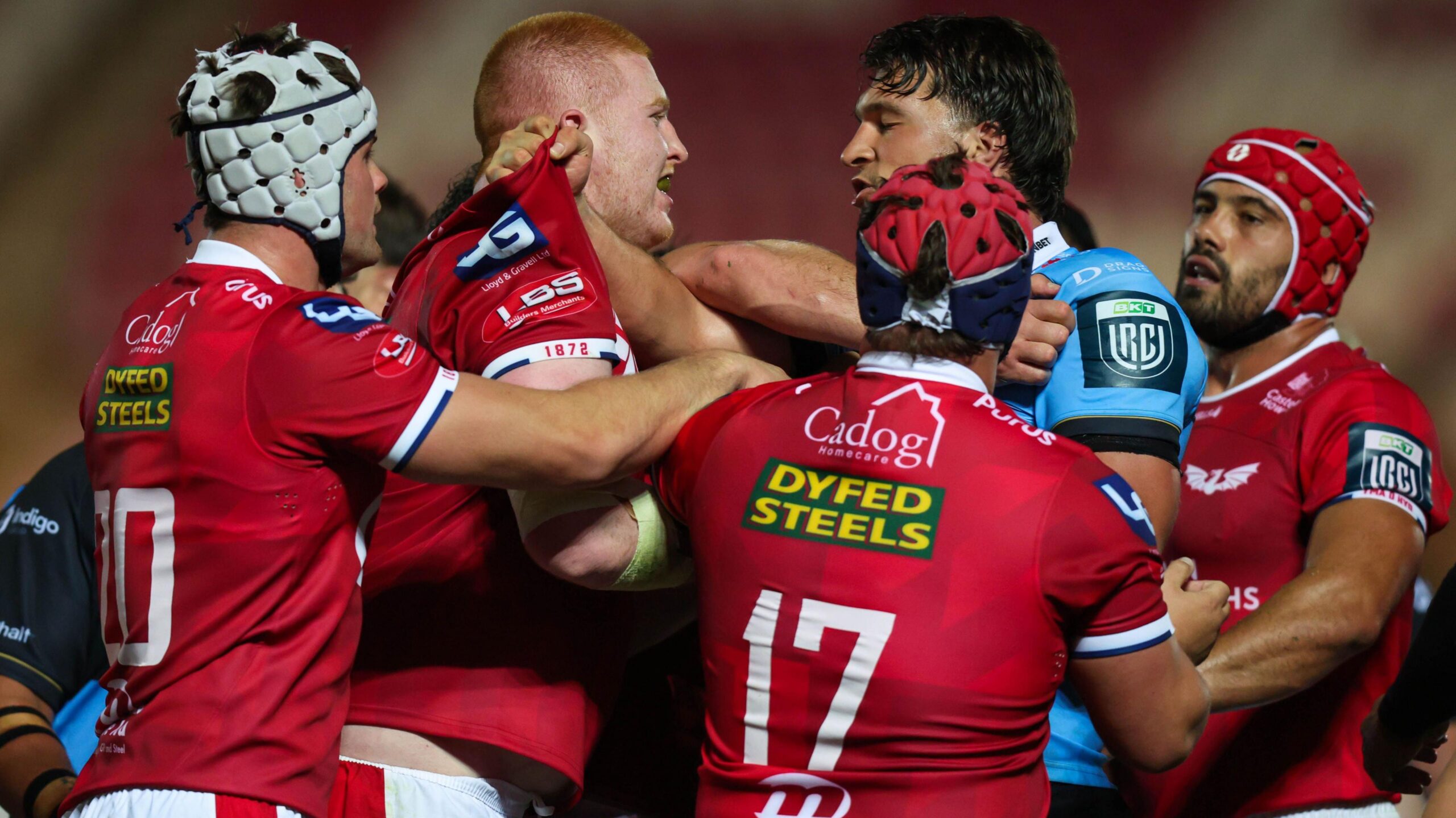 Scarlets and Cardiff players grapple