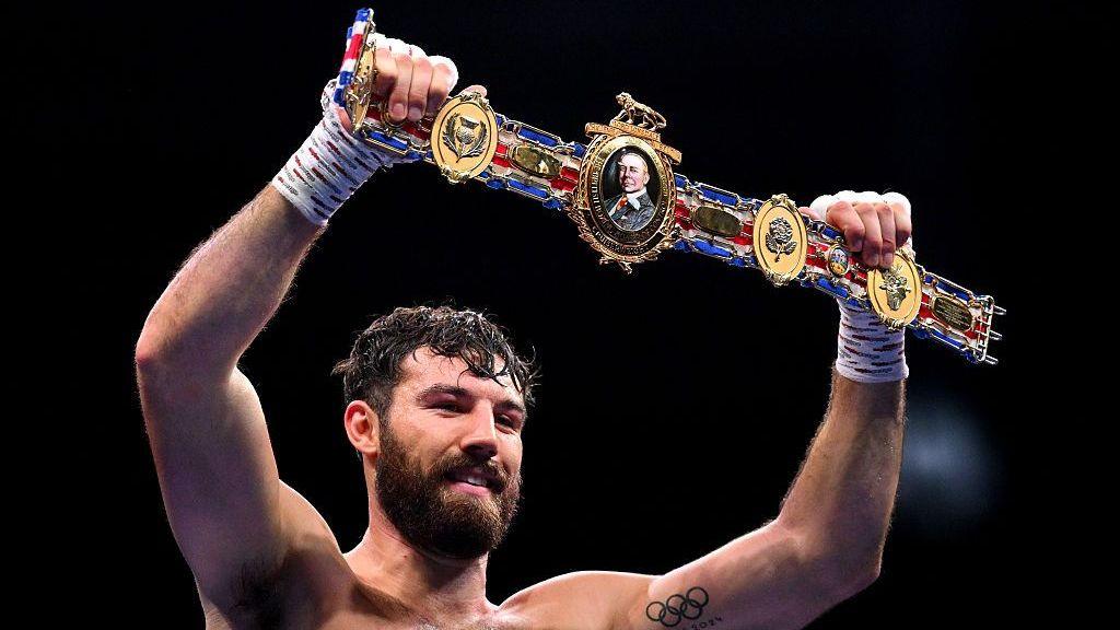 Pat Brown holding the British title in the air