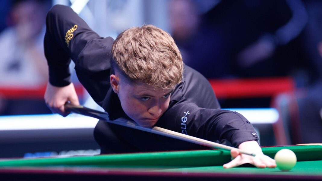 Teenager Moody knocks Higgins out of British Open Stan Moody, wearing a black shirt, looks down the line of his cue as he lines up a shot on a snooker table