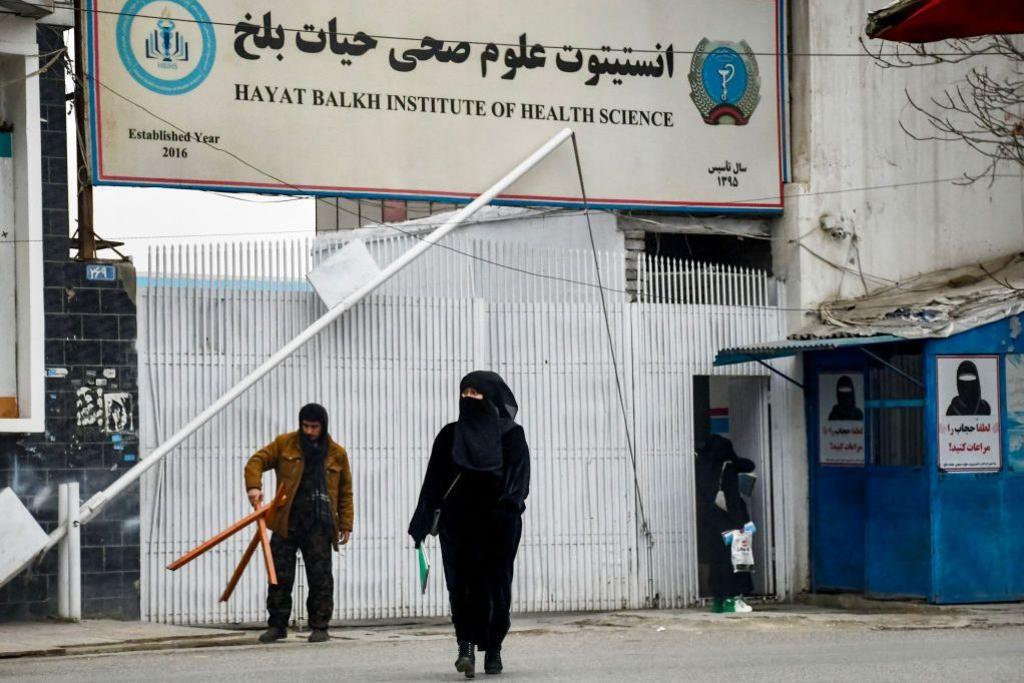An Afghan female student walks out the Hayat Balkh Institute of Health Science in Mazar-i-Sharif on December 8, 2024