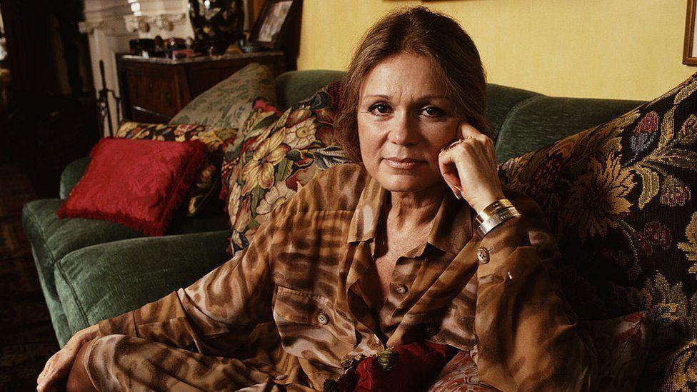 Gloria Steinem lying on a couch