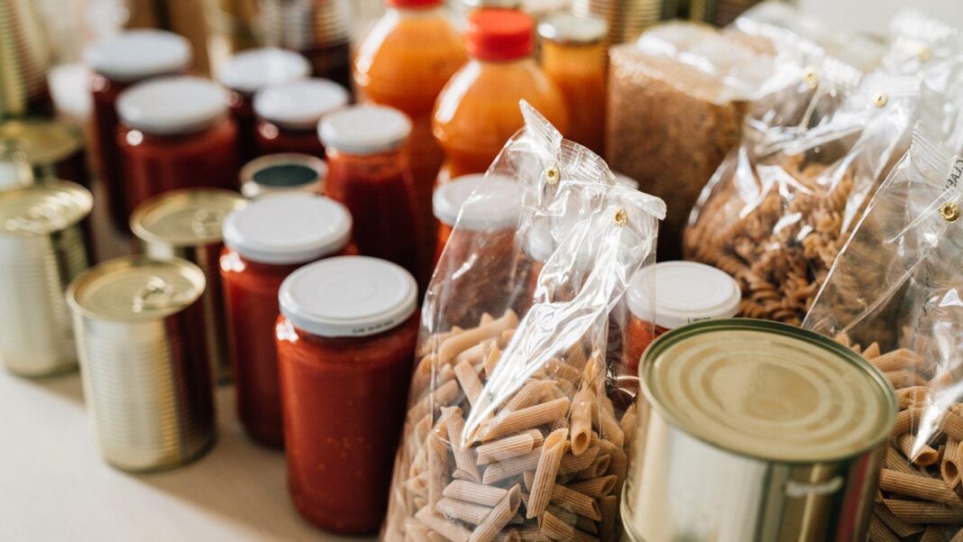 Stock up on food to prepare for extreme weather, minister says Stock photo shows jarred food and household pantry items stacked on a shelf in close up.