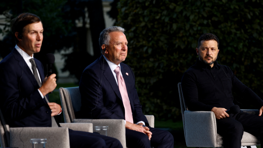 Kushner, Witkoff and Zelensky sit on grey armchairs as Zelensky looks at the two men, who look forward