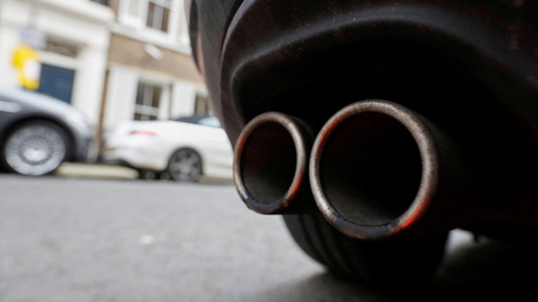 Leaving your engine running in Wales could cost you £150 An exhaust pipe on the back of a car. A wheel can be seen, with two cars out of focus in the background