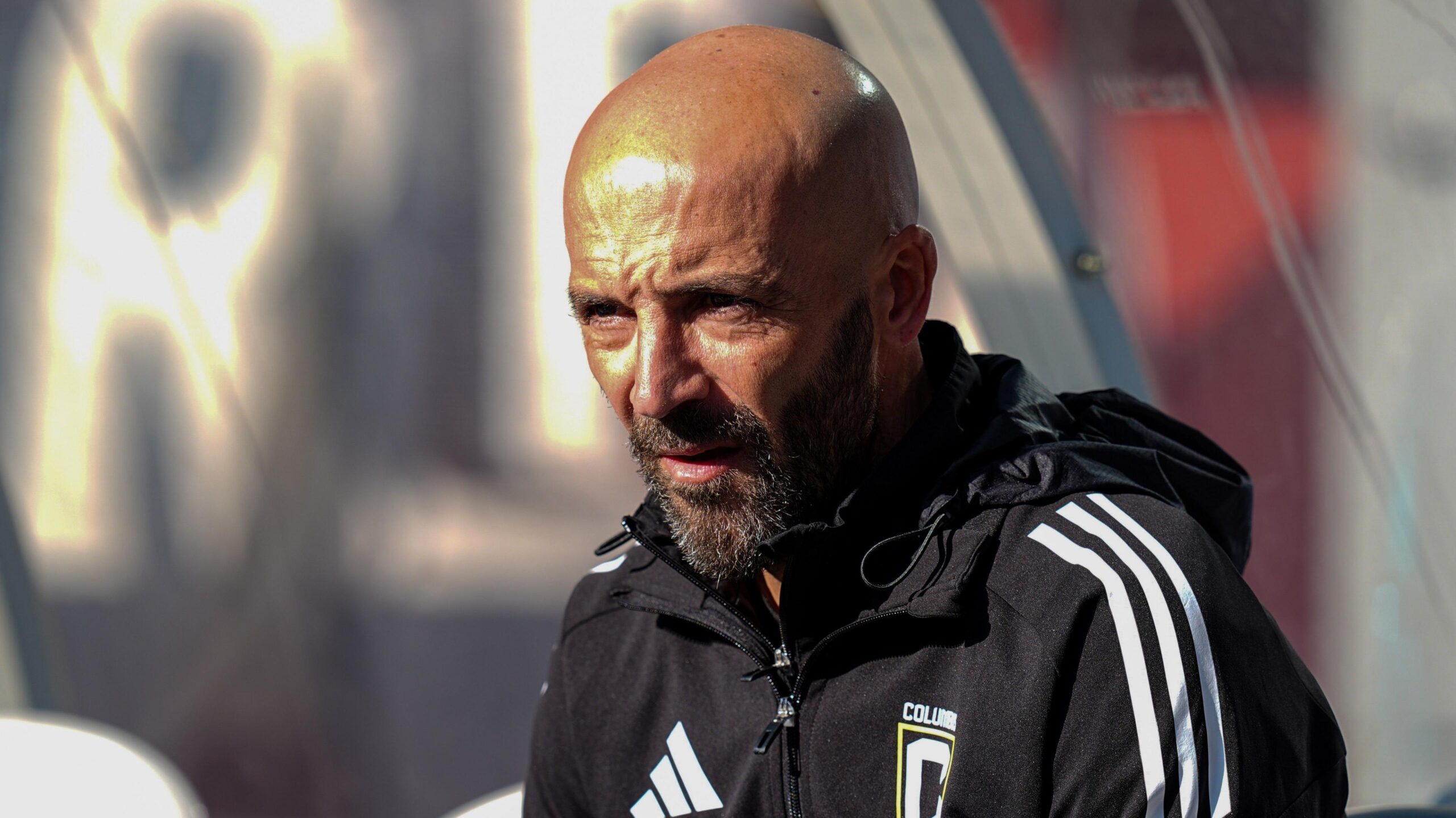Columbus Crew reserve team coach Federico Higuain, wearing a black tracksuit, watches on from the touchline