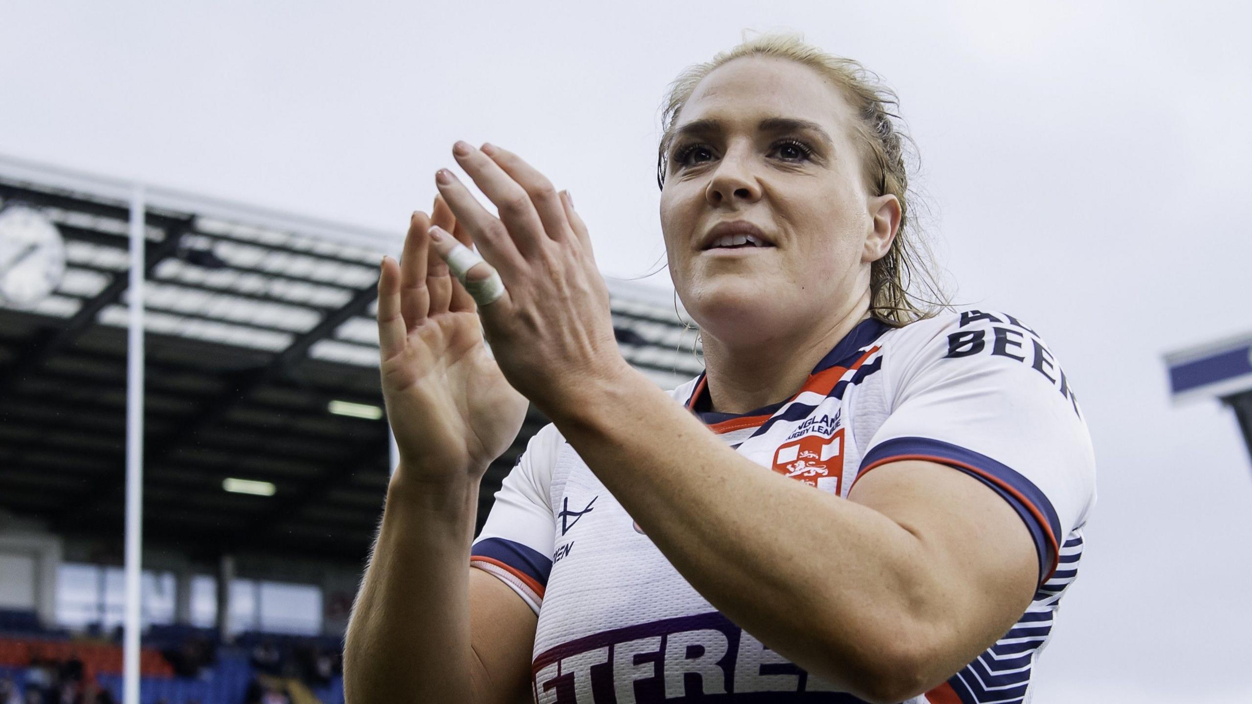 Amy Hardcastle in an England shirt applauding fans