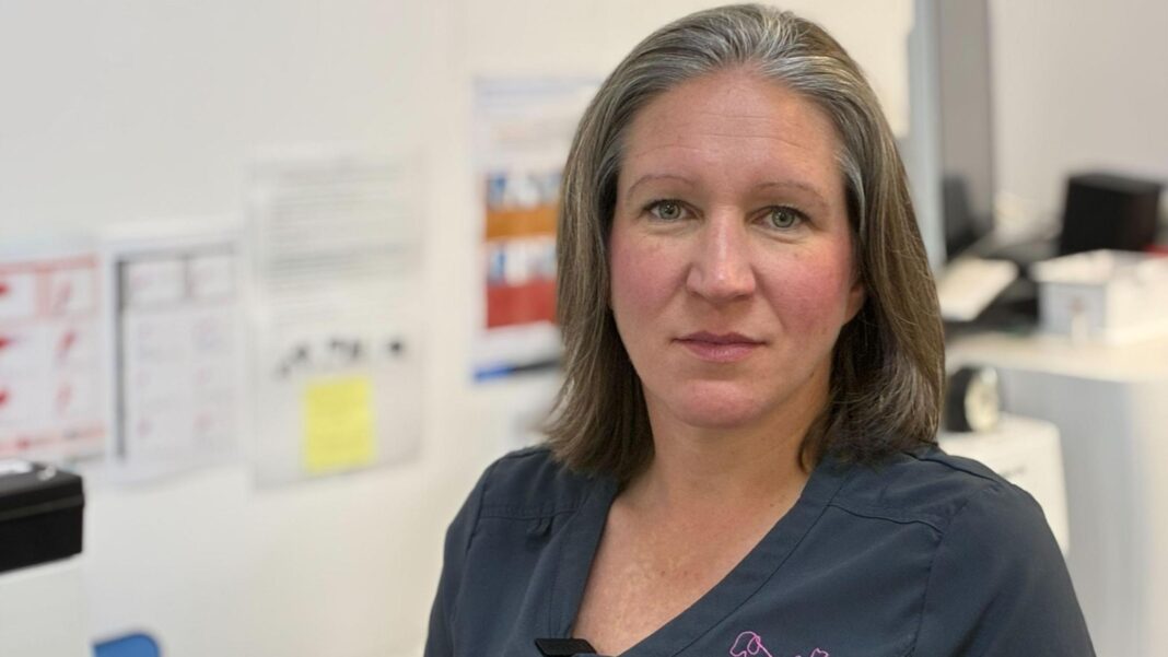 Vet prescription fees capped under rule changes Vet Cate Titterton wearing dark blue scrubs standing in her surgery