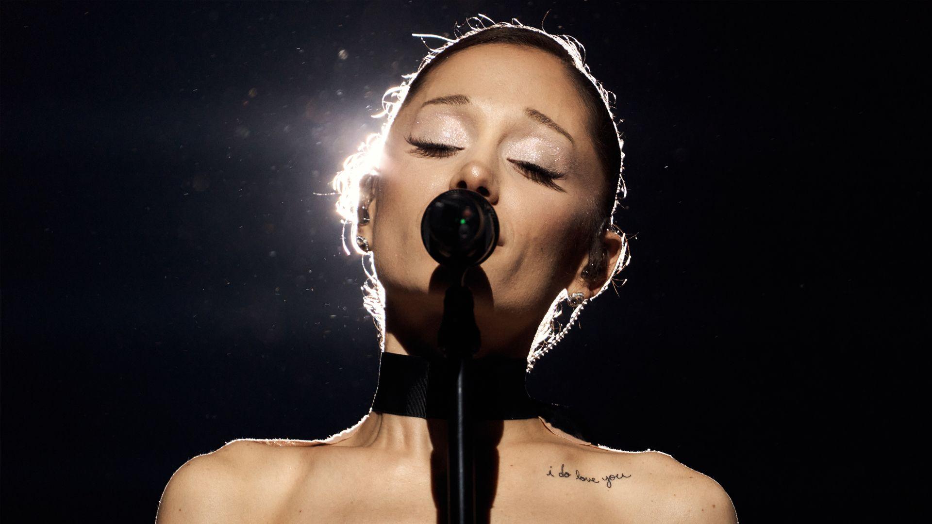 Ariana Grande singing into a microphone