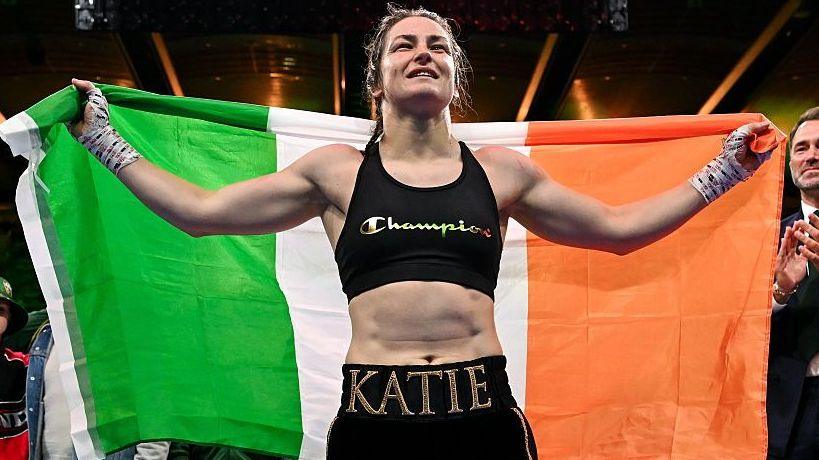 Katie Taylor holds the Ireland flag over her shoulders