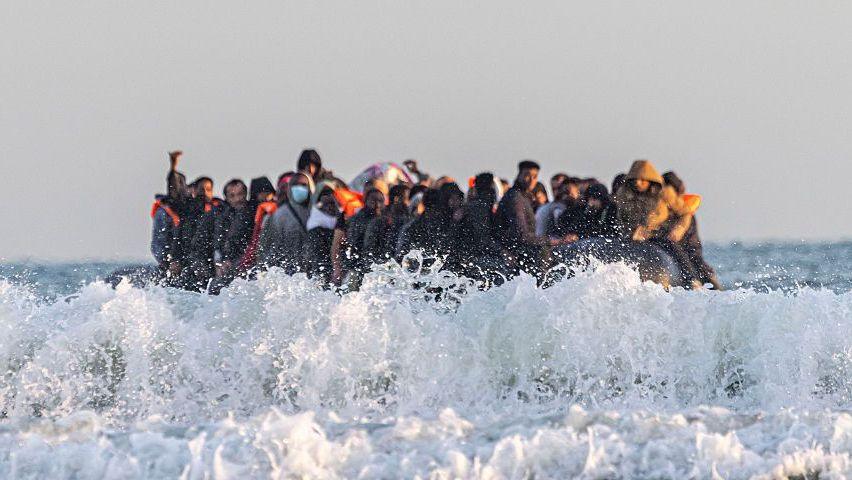 A small boat crowded with people.