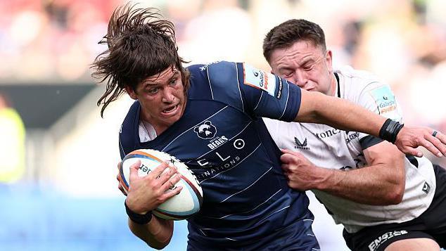 Benhard Janse van Rensburg holds off an opponent as he runs with the ball for Bristol Bears