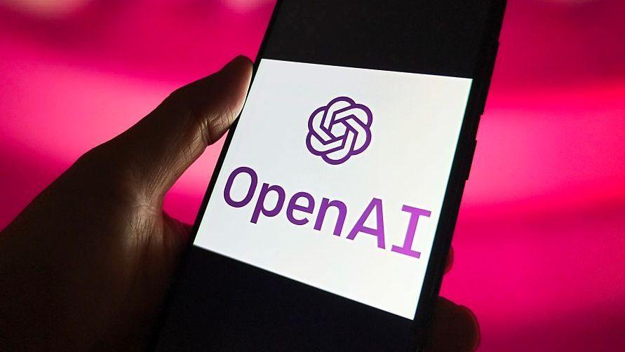 OpenAI agents hijacked German website before Hugging Face hack, report claims A hand holds a phone which has the OpenAI logo on its screen.