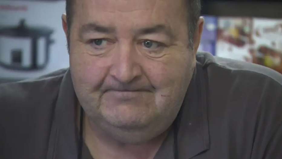 Image shows Gerard Woodhouse, in close up, from a TV appearance filmed at the foodbank he ran. He is looking pensive, and staring away from the camera.