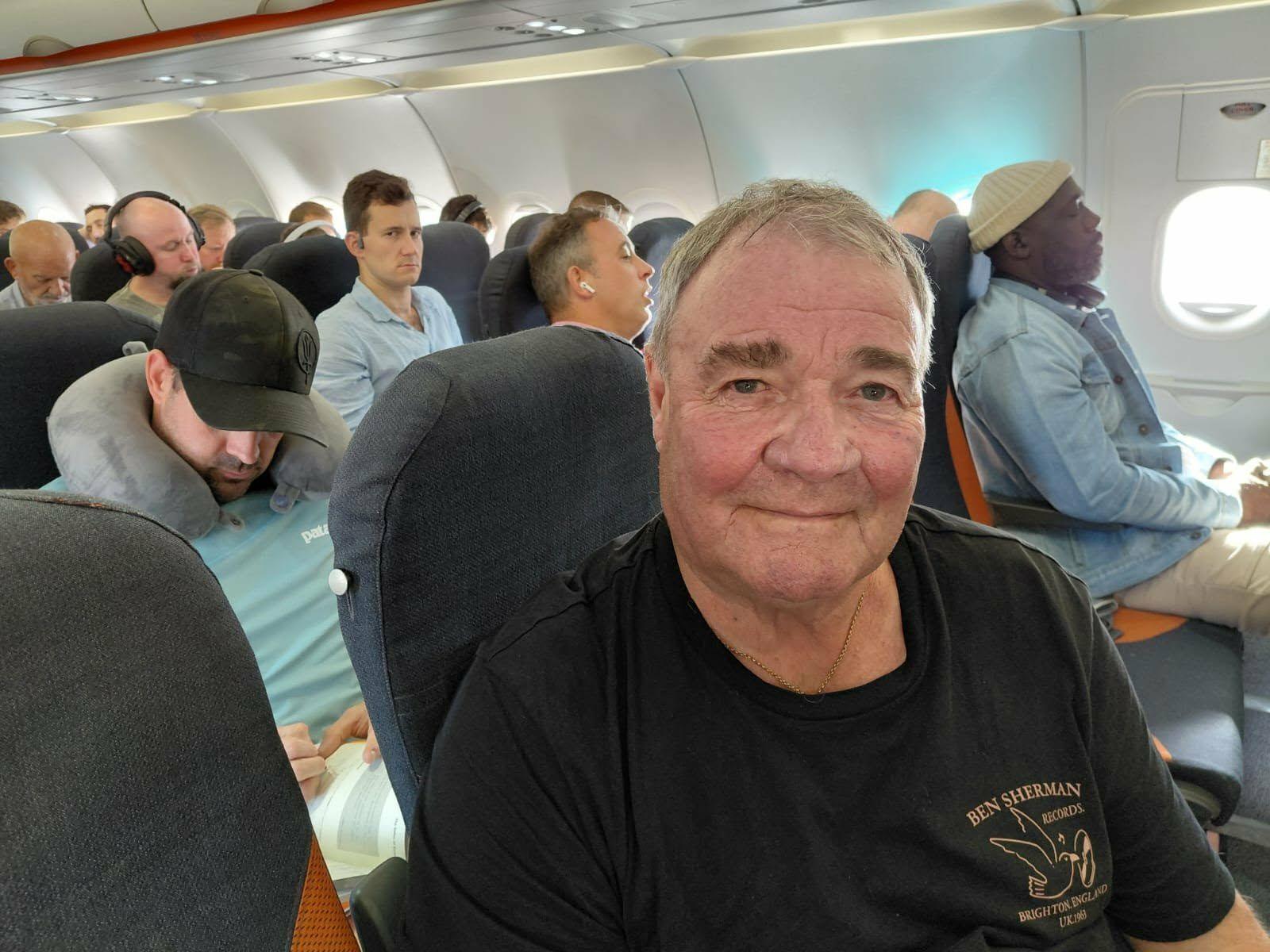 Phil sitting on a plane