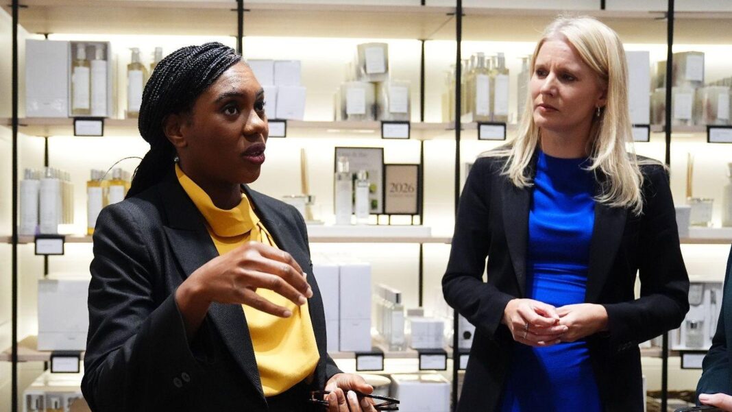 Tories pledge to bring back tax-free shopping for tourists Conservative leader Kemi Badenoch and shadow culture secretary Rebecca Paul visit a shop in Bicester Village. Behind them are shelves with toiletries and candles.