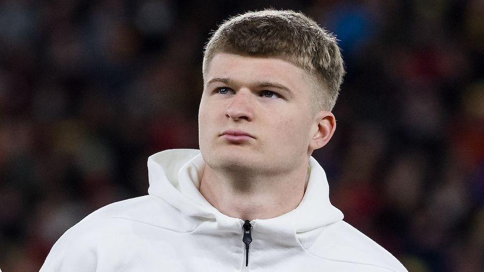 Jordan James lining up in a Wales warm-up jacket