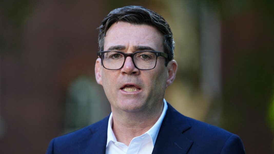 Andy Burnham wearing a navy suit and a white shirt.
