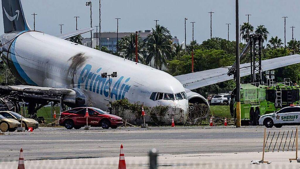 Crews investigate the site of an Amazon cargo plane crash at Miami International Airport on 8 September