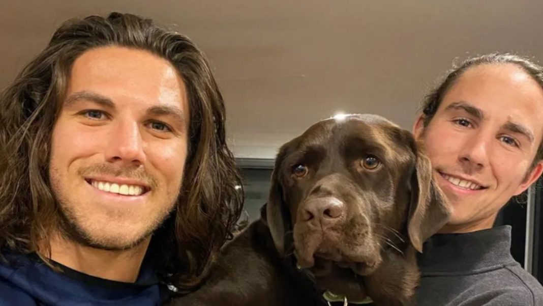 Trial over alleged murders of Australian surfer brothers starts in Mexico A young man with shoulder-length brown hair and light stubble smiling at the camera, and another young man to his right and a brown dog in between them