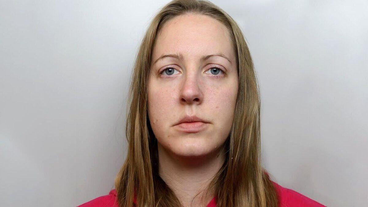 Custody image of Lucy Letby, who has long blonde hair and is wearing a red top.