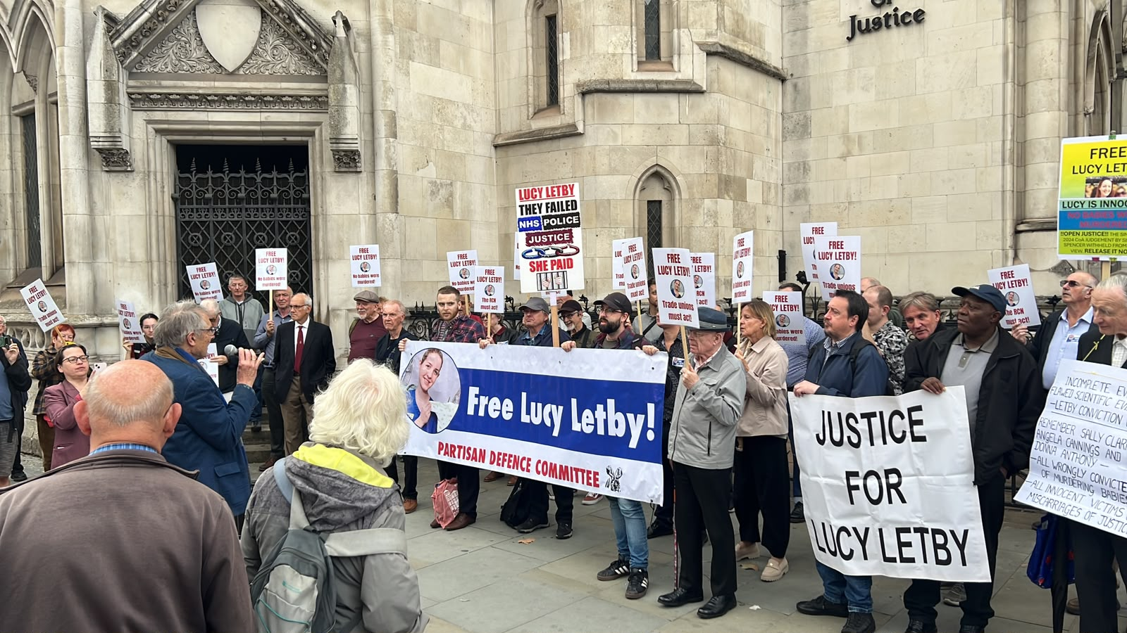 Group of protesters outside the Royal Courts of Justice holding banners and signs that read "Free Lucy Letby!" and "Justice for Lucy Letby"