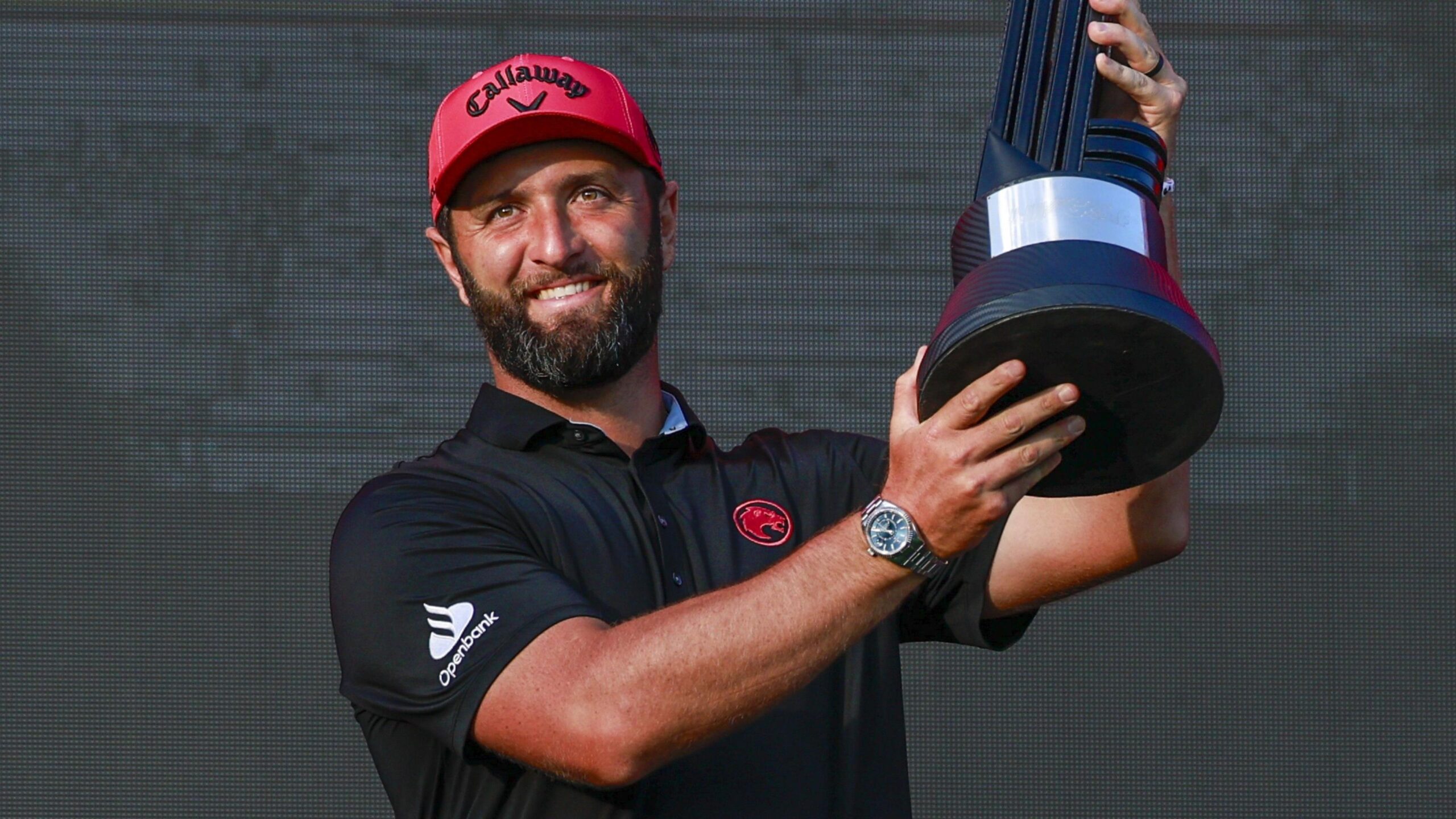 Jon Rahm poses with the LIV Golf trophy