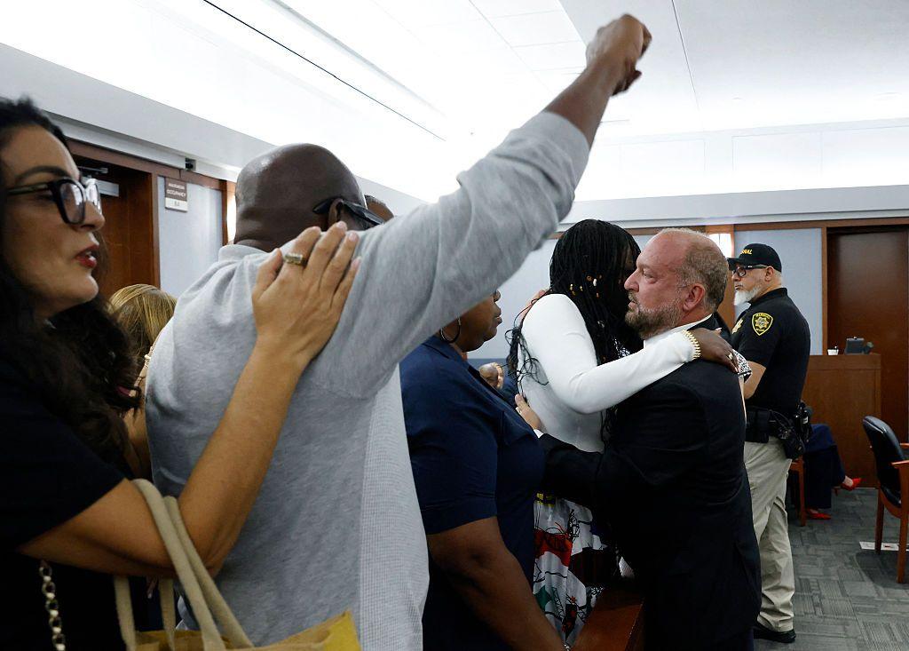 A man pumps his fist in the air as friends and family of Tupac Shakur celebrate a guilty verdict in the trial of Duane "Keffe D" Davis