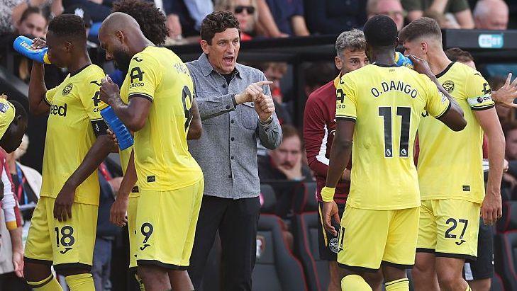 Brentford boss Keith Andrews speaks with his players on the touchline during a break in play in the Premier League match against Bournemouth