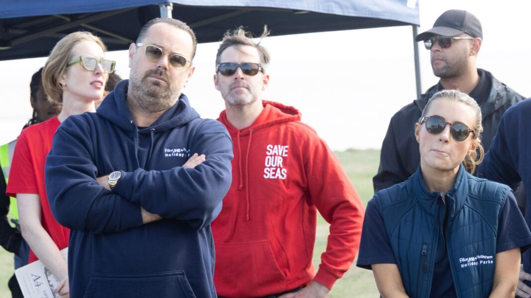 Danny Dyer and Becky Hill join water industry protest A man, Danny Dyer, and a woman, Dani Dyer, stood next to each other in front of a group of protesters.