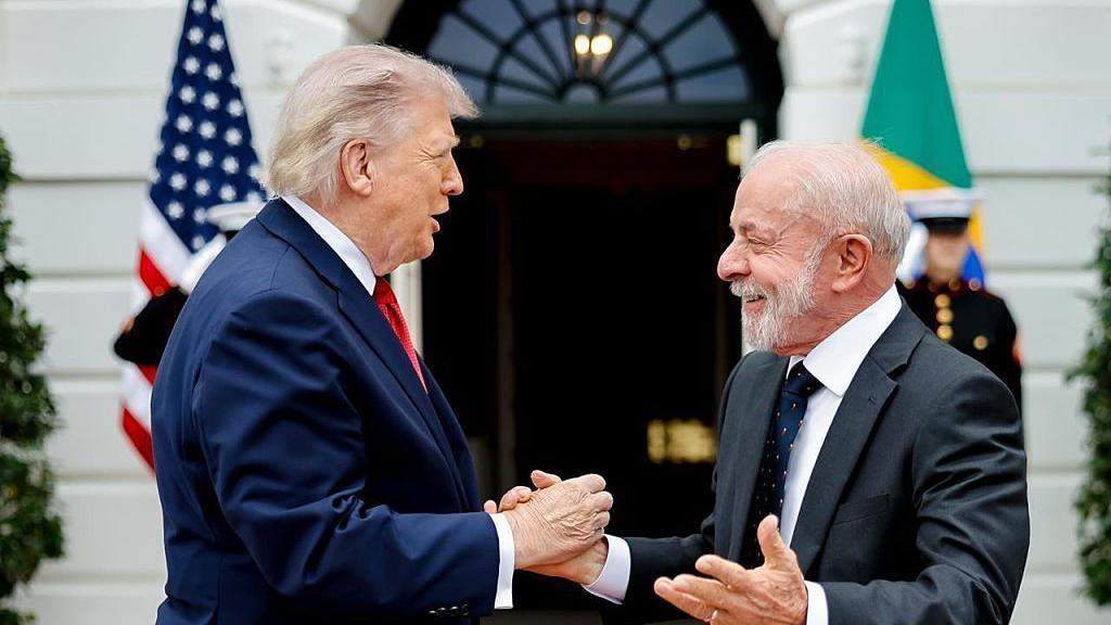 US President Donald Trump and Brazil President Luiz Inácio Lula da Silva greet each other at the White House in Washington on Thursday in this handout photo from the Brazilian government.