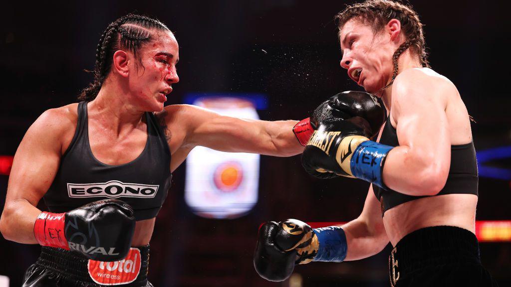 Amanda Serrano punches Katie Taylor in the mouth